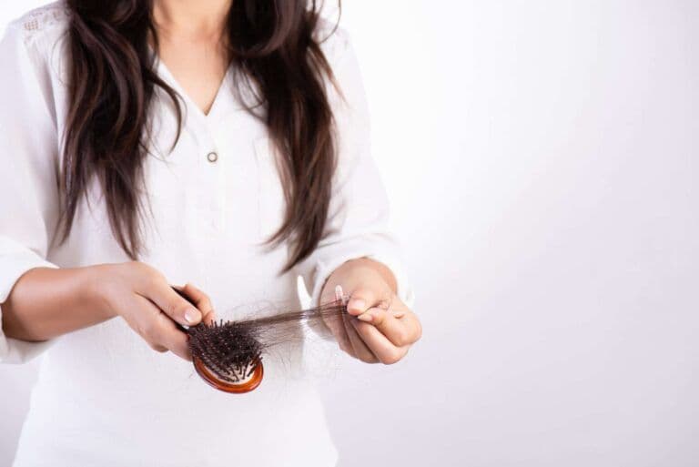 A woman holding a hairbrush