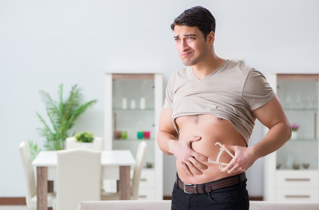 A man looking in the mirror off-screen with a fat pinching claw