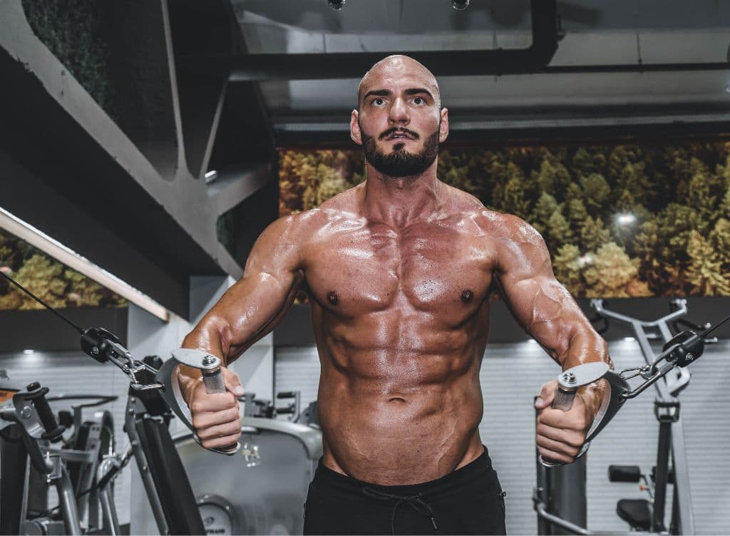 A ripped man working out in the gym