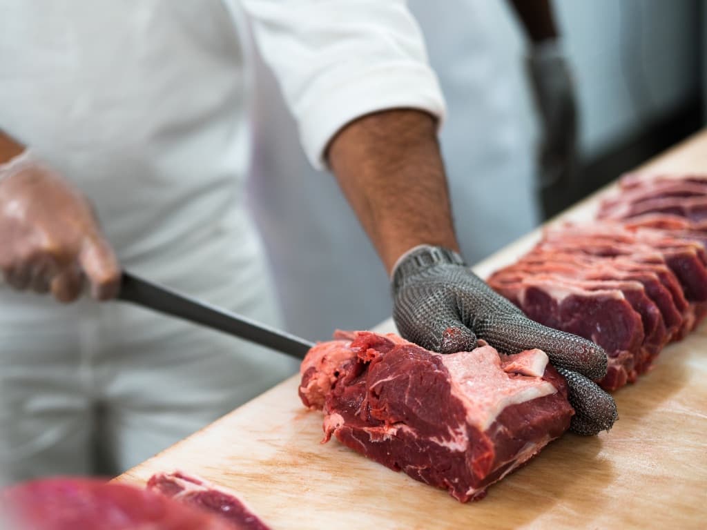 Butcher cutting meat