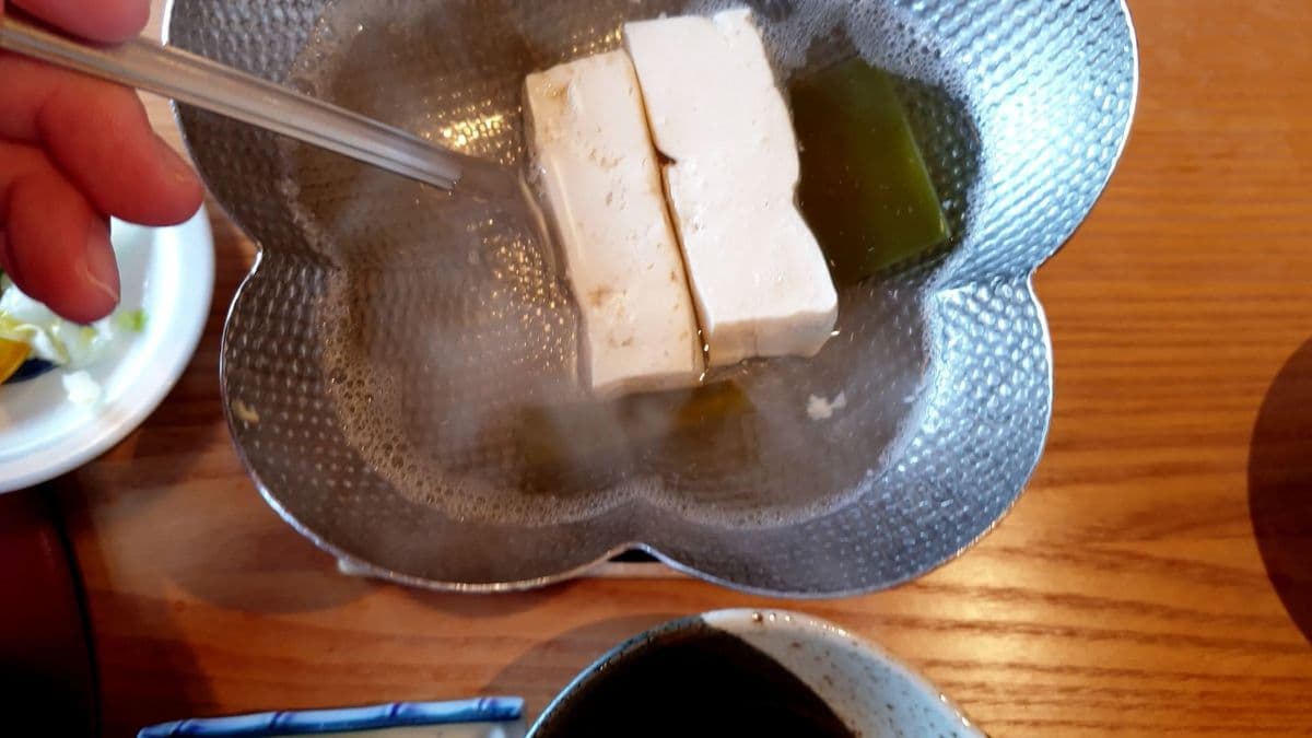 Someone cooking some soy blocks