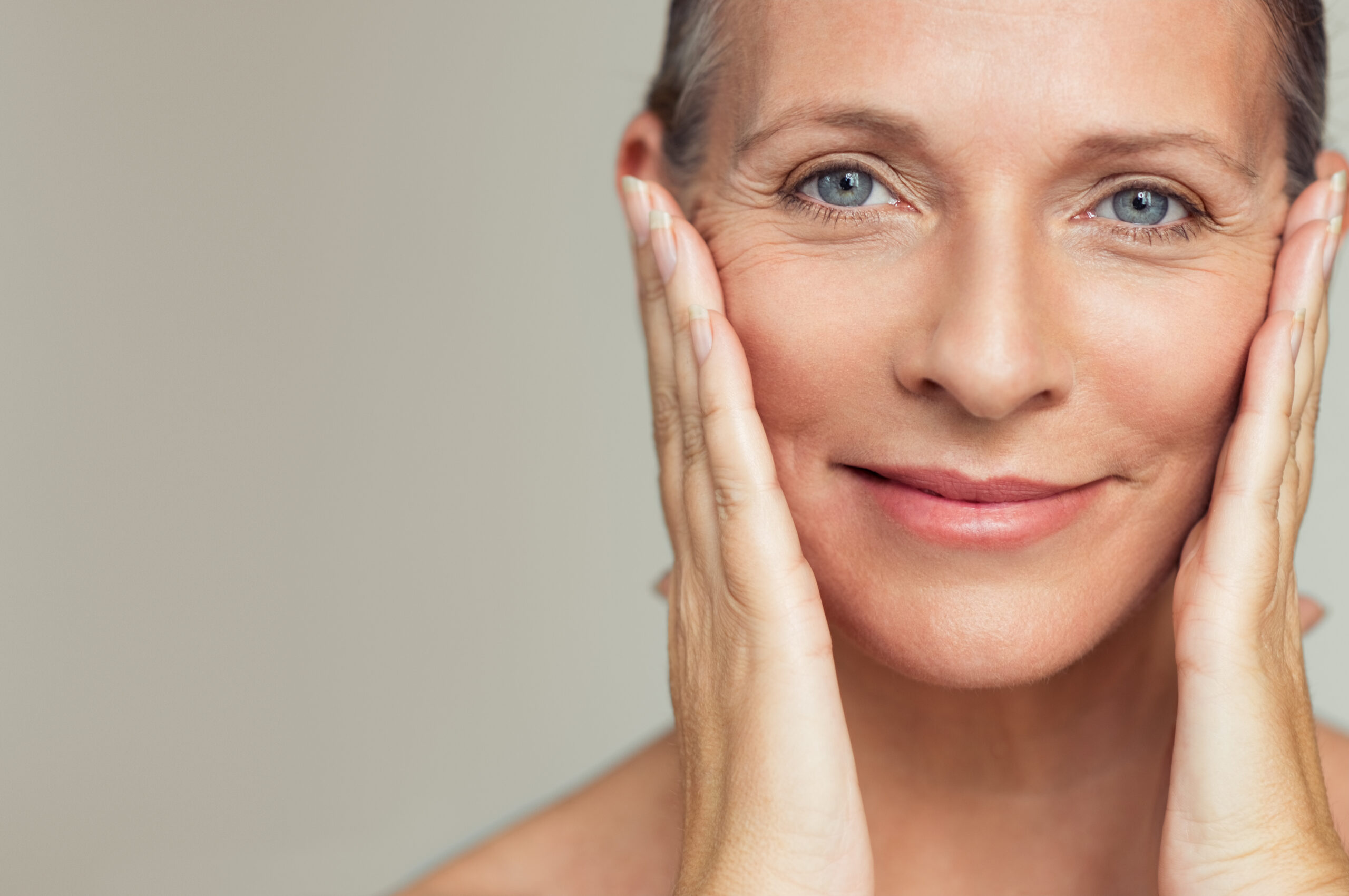 close up of a senior womans face smiling and having perfect skin